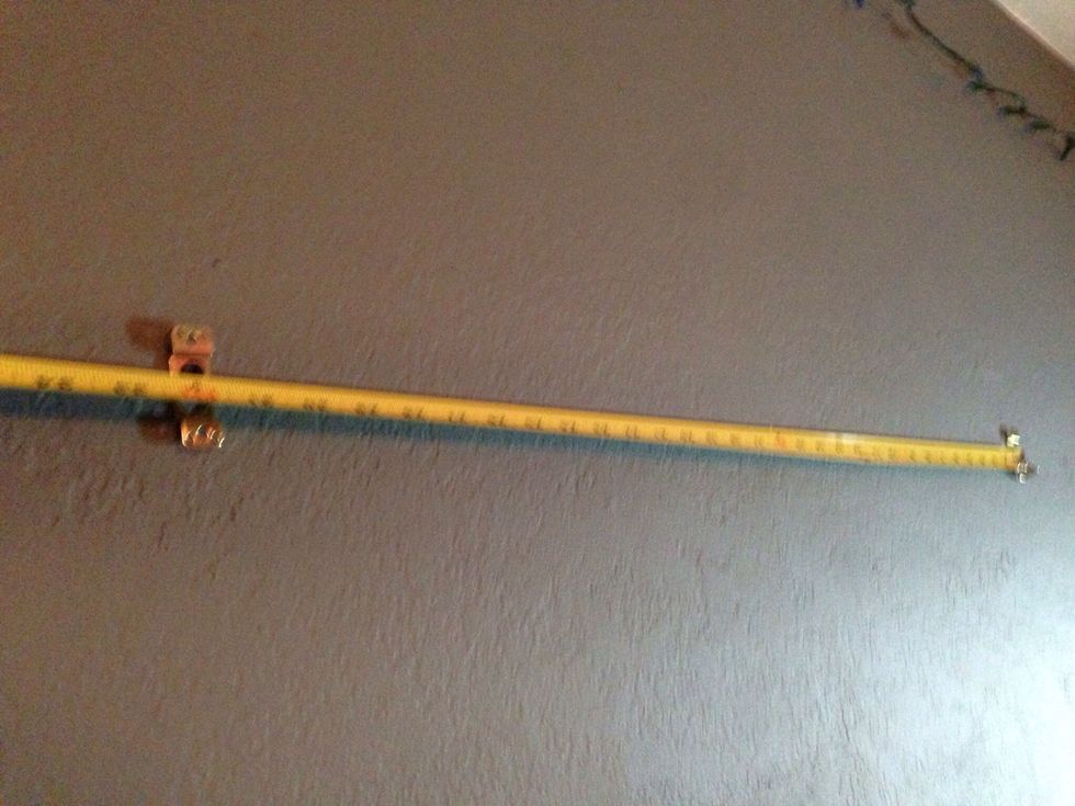 Measure another location at least two studs away. And install a second screw in the same manner as the first screw. Make sure the locations are level with each other.