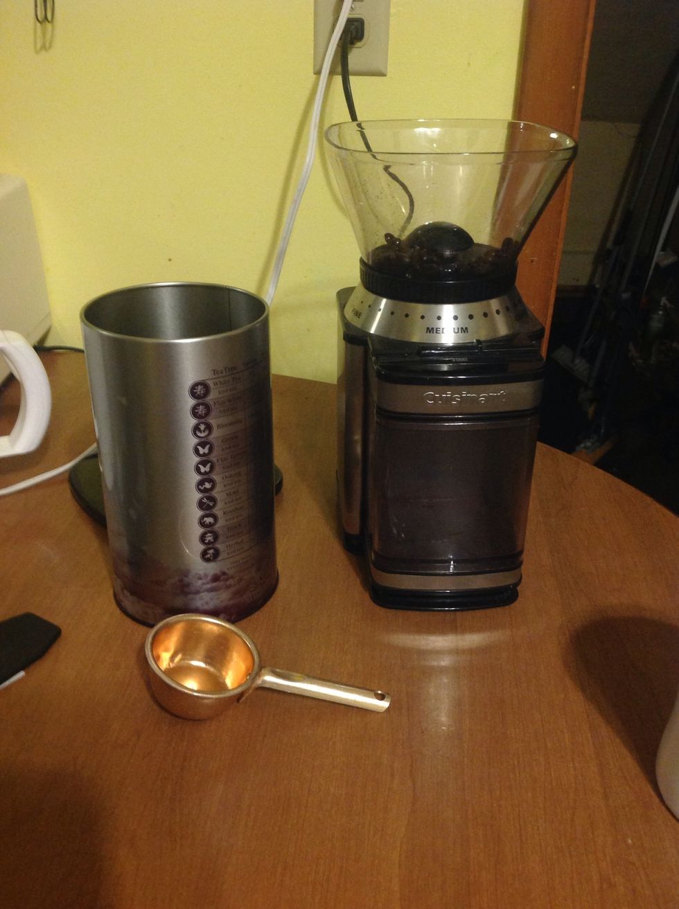 Measure coffee beans using a 1/4 cup and place them into the Burr Grinder.