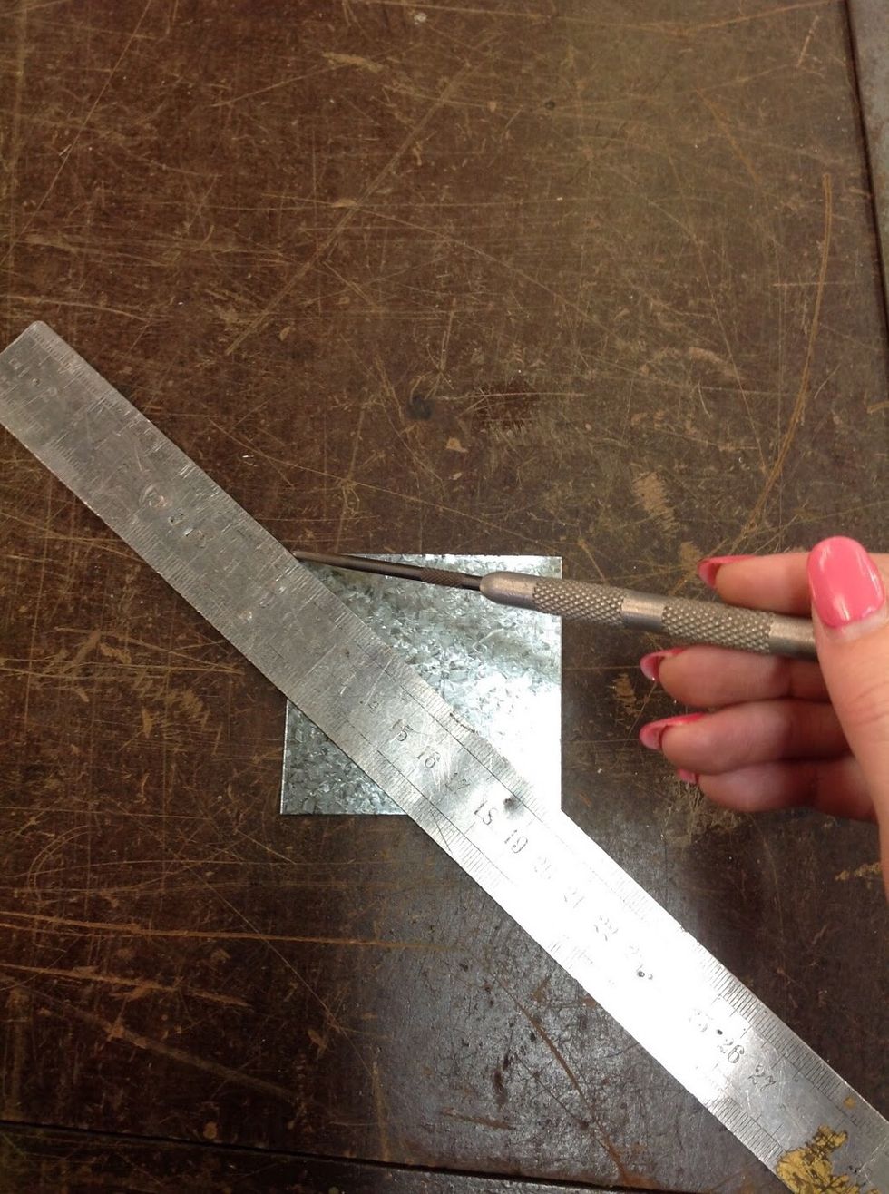 Measure corner to corner to find the centre using a square