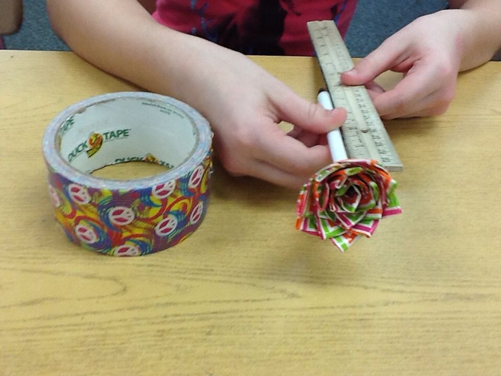 Measure how long the pen is from the end of the flower to where the part you write with is