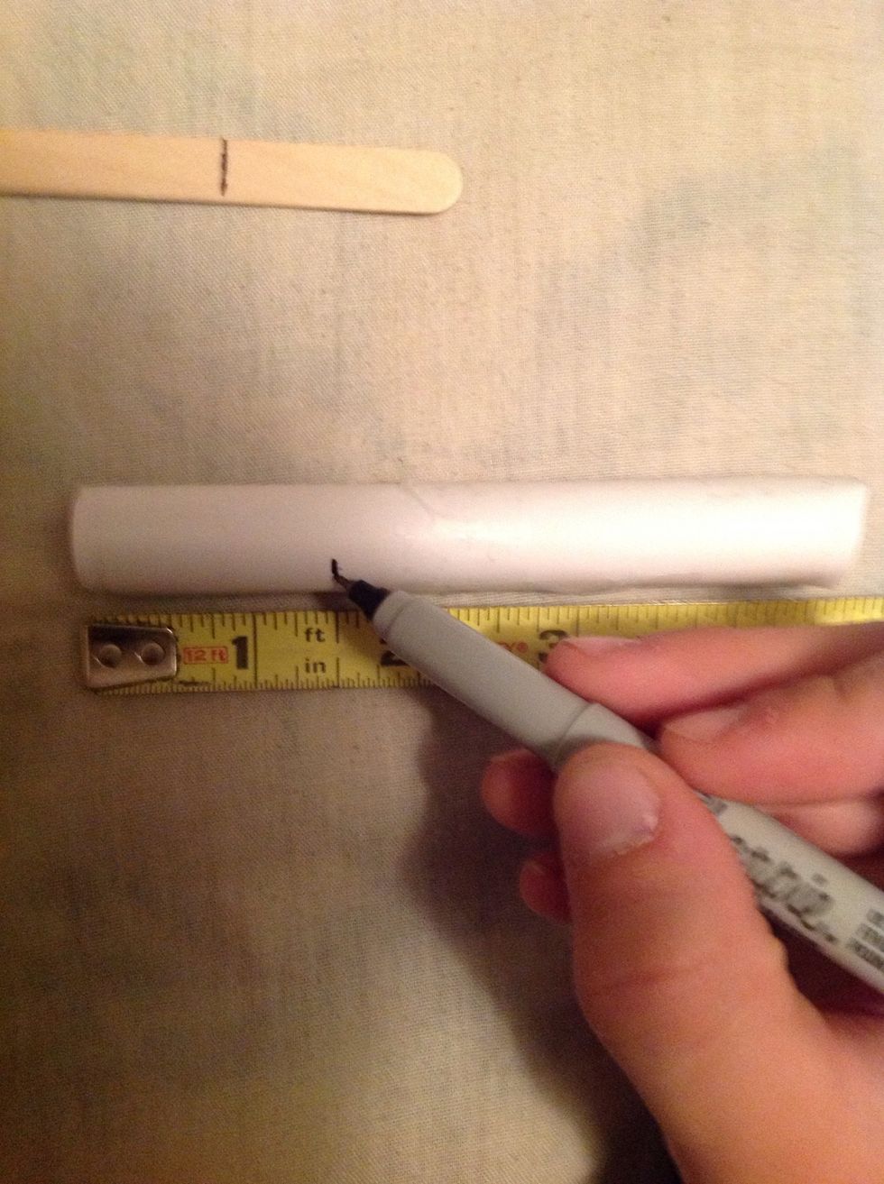 Measure one and a half inches on the one side of the paper tube, you want to do this to one side of each of the paper tubes and mark them.