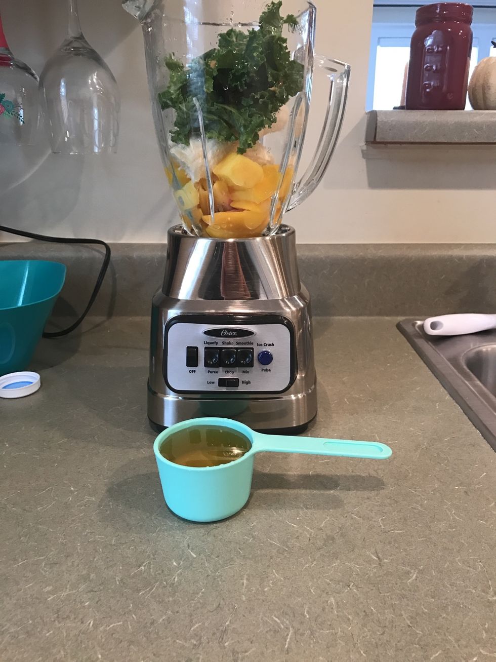 Measure out 1/2 cup of apple juice and add it to the blender