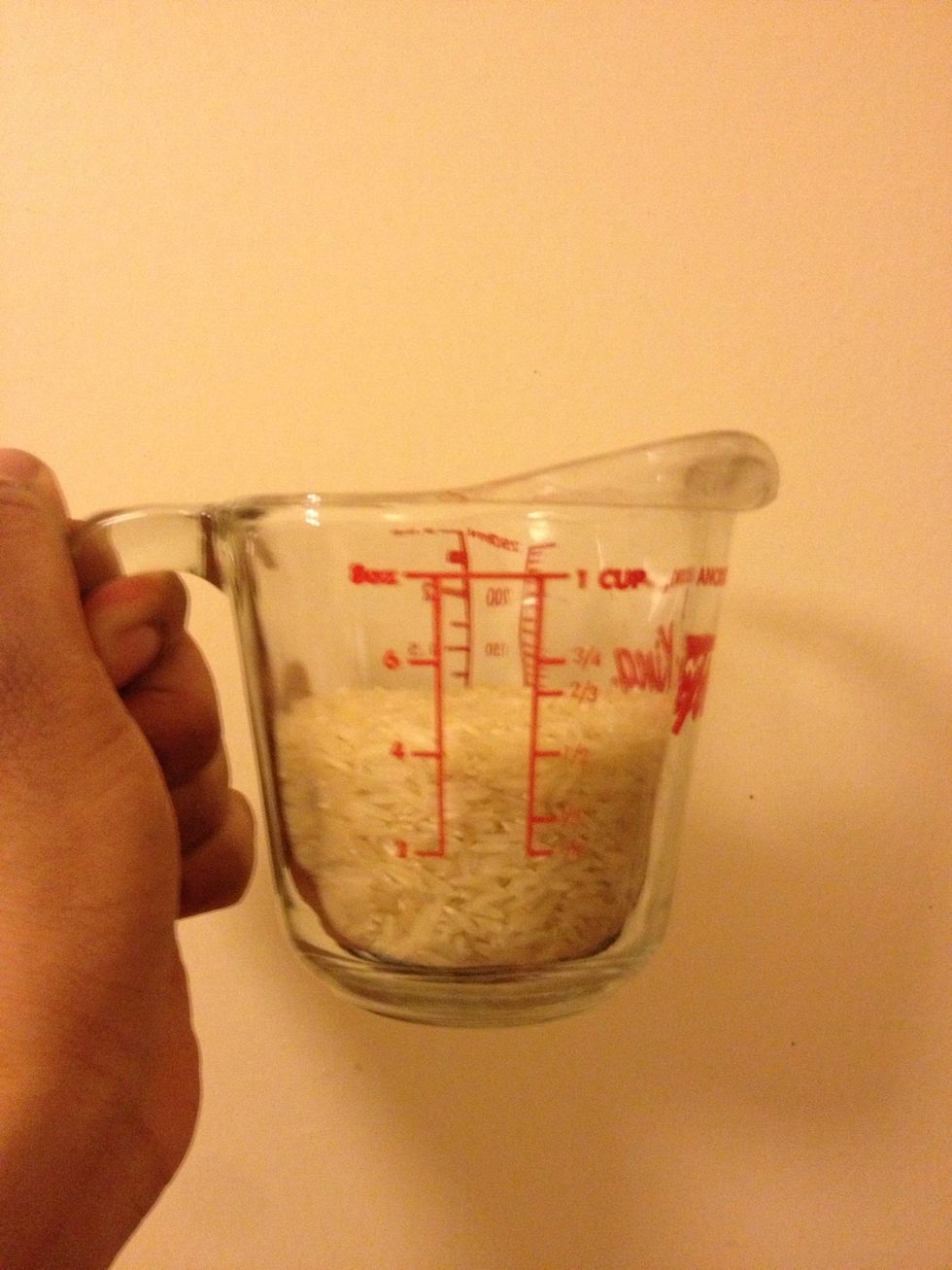 Measure out 1/2 cup of rice. Rinse it under water or soak it for half an hour for fluffier rice.