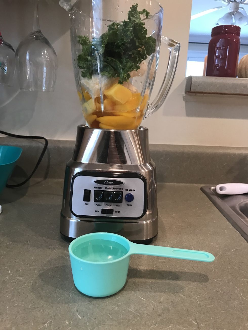 Measure out 1/2 cup of water and add it to the blender
