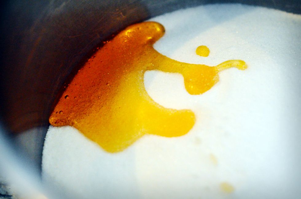 Measure out 2 cups of white sugar and 1 tablespoon of light corn syrup into a heavy bottomed saucepan with high sides.