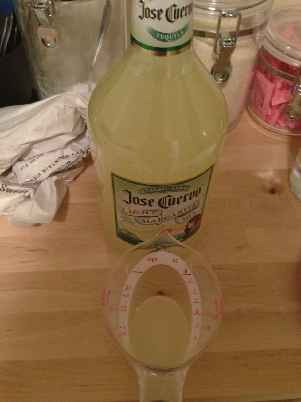 Measure out 2 oz of sweet n sour or lime juice if you are more traditional.