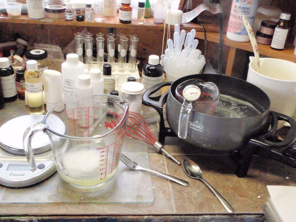 Measure out 20 g beeswax, 25 g butter, and 54 g oil on a scale in a heatproof jug. Heat until melted.