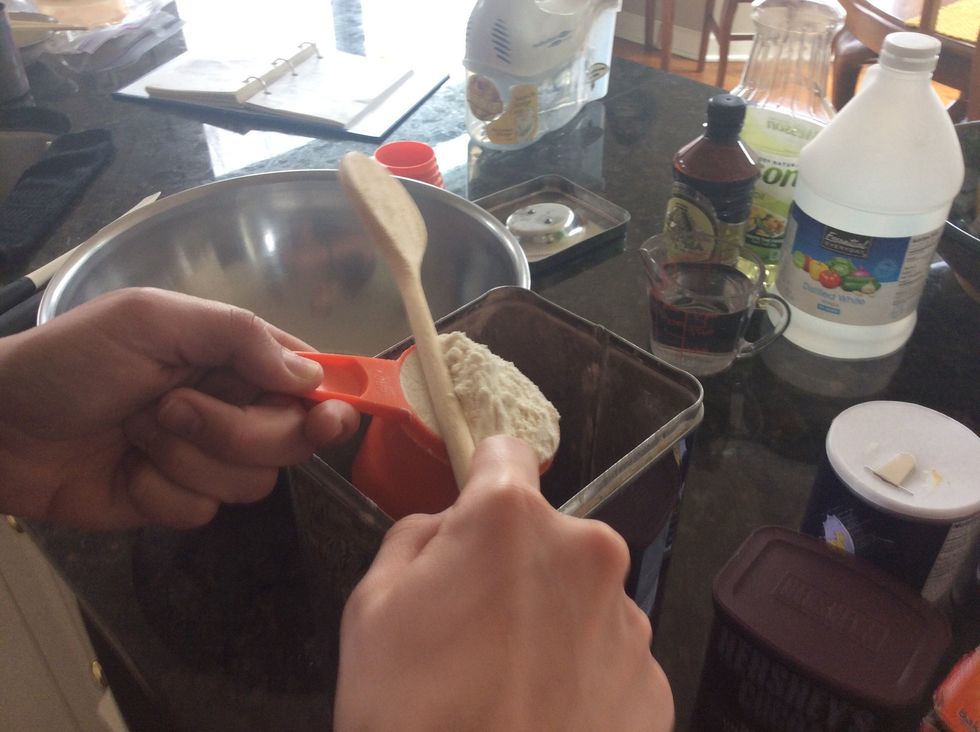 Measure out 3 cups of flour using the dipping method so as to not compress the flour. Use the wooden spoon to level it off. Place these 3 cups of flour directly into the large mixing bowl.