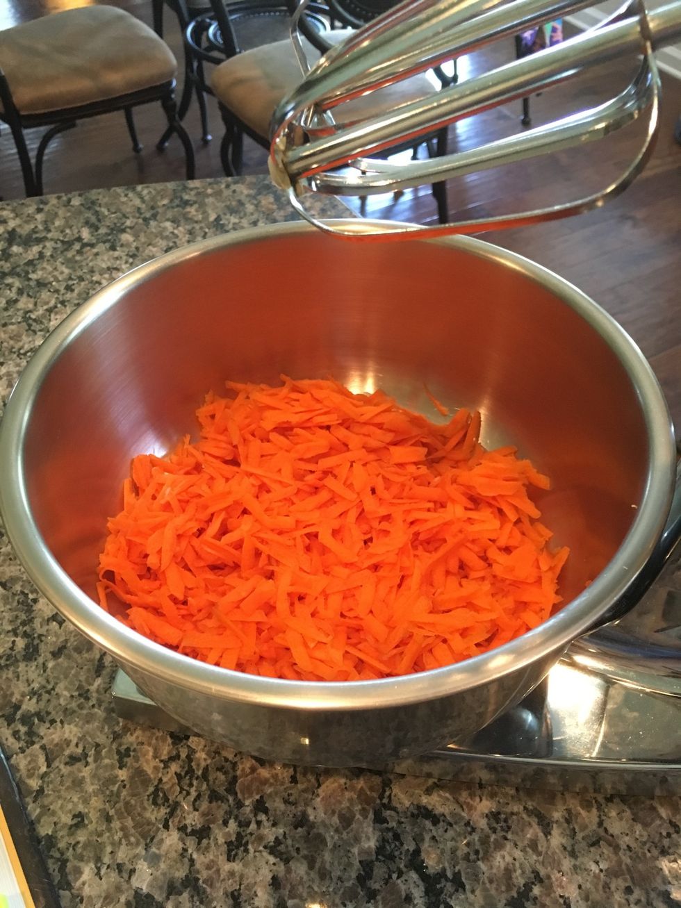 Measure out 3 cups of grated carrots and place them in a mixing bowl.