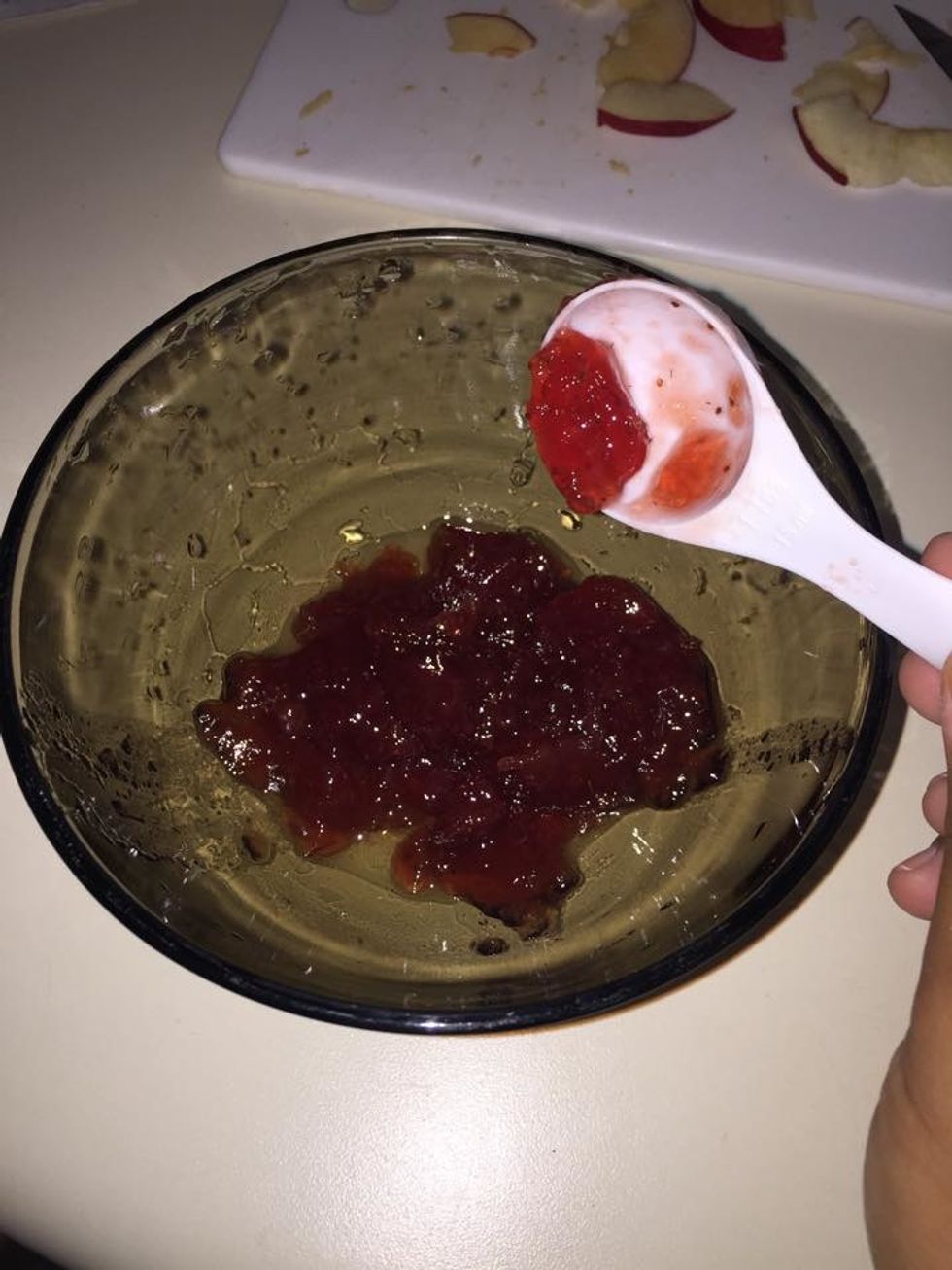 Measure out 3 tablespoons of strawberry preserve in a bowl.