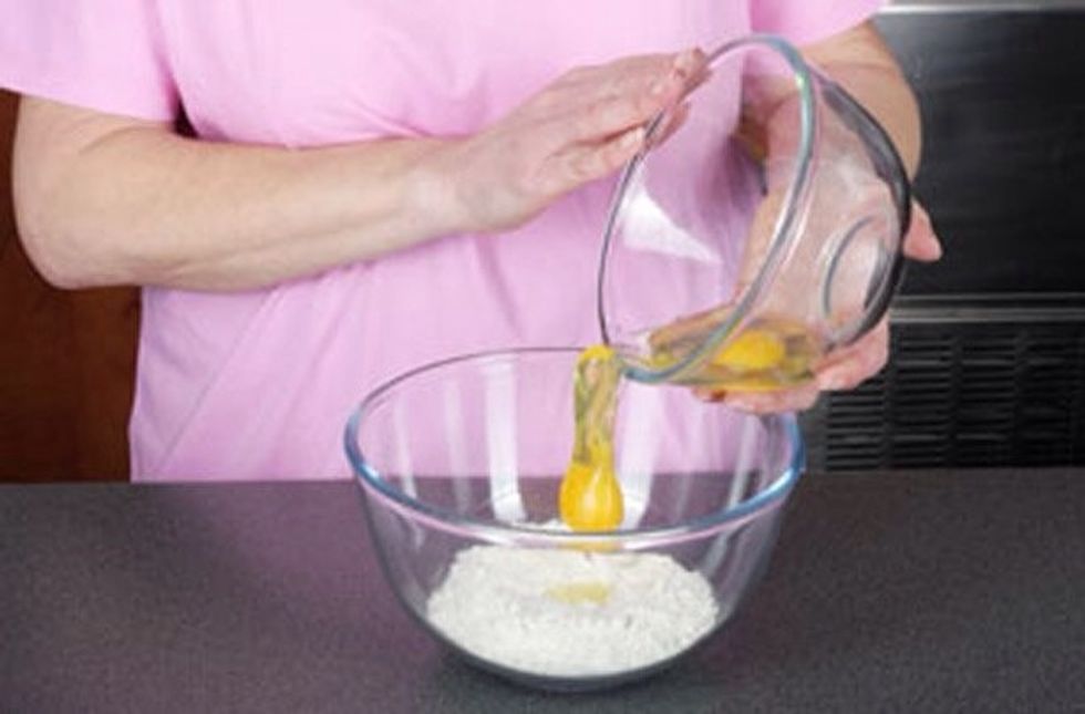 Measure out flower and add the eggs to it