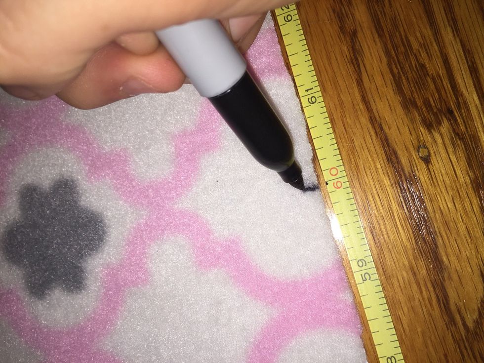 Measure out lengths of 5 feet (60 inches) on two touching sides and mark it with a Sharpie.