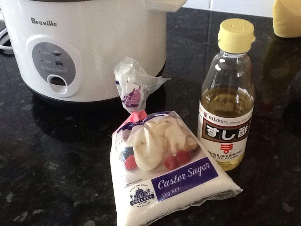 Measure out the caster sugar and rice vinegar and add to the cooked rice. Here you can dissolve the sugar in the vinegar but I just add it to the hot rice and it works fine.