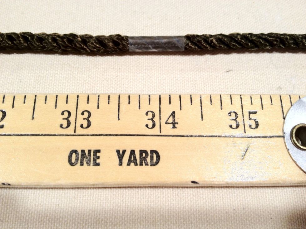 Measure out the decorative twist cord to 34" long. Wrap a piece of scotch tape at the 34" mark before cutting the cord. This will keep the cord from unraveling.