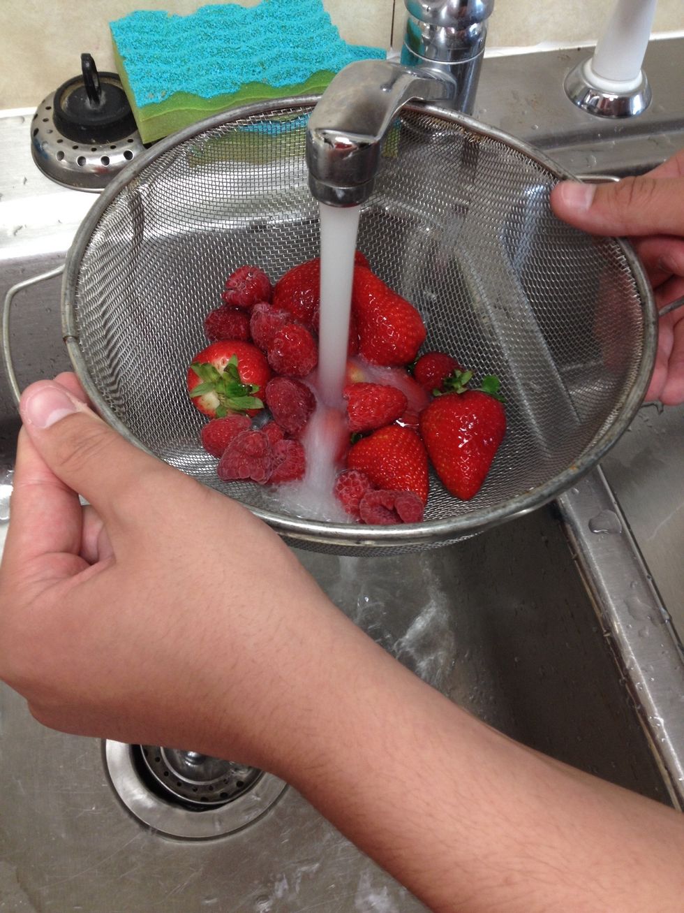 Measure out the raspberries and strawberries and then rinse.