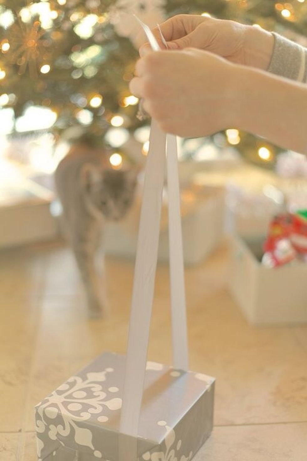 Measure out your ribbon so it wraps around the package 2.5 times. No need for fancy cut ends. The ribbon ends will be hidden