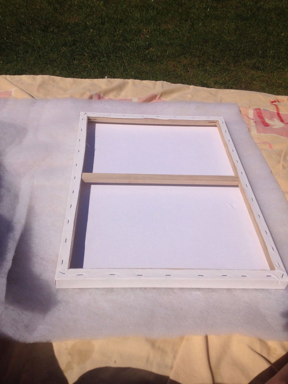 Measure the batting with about 4 inches on each edge. This will make it easier to attach to the canvas.