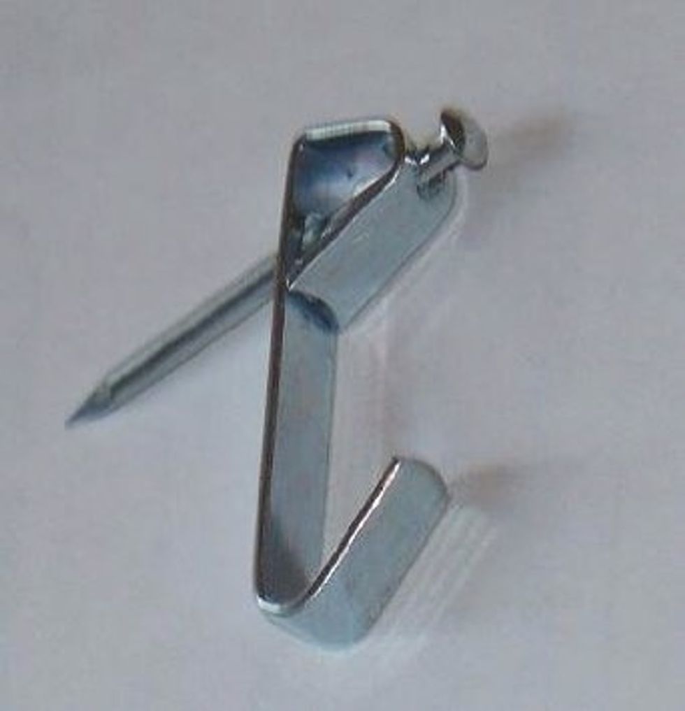 Measure the distance between the two eyehooks and attach two picture hangers on the wall the same distance apart.