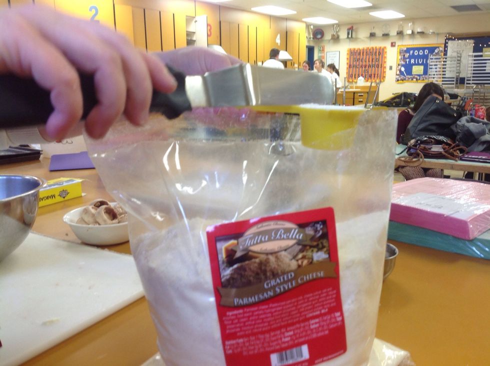 Measure the Parmesan cheese with a metal spatula and a dry measuring cup.