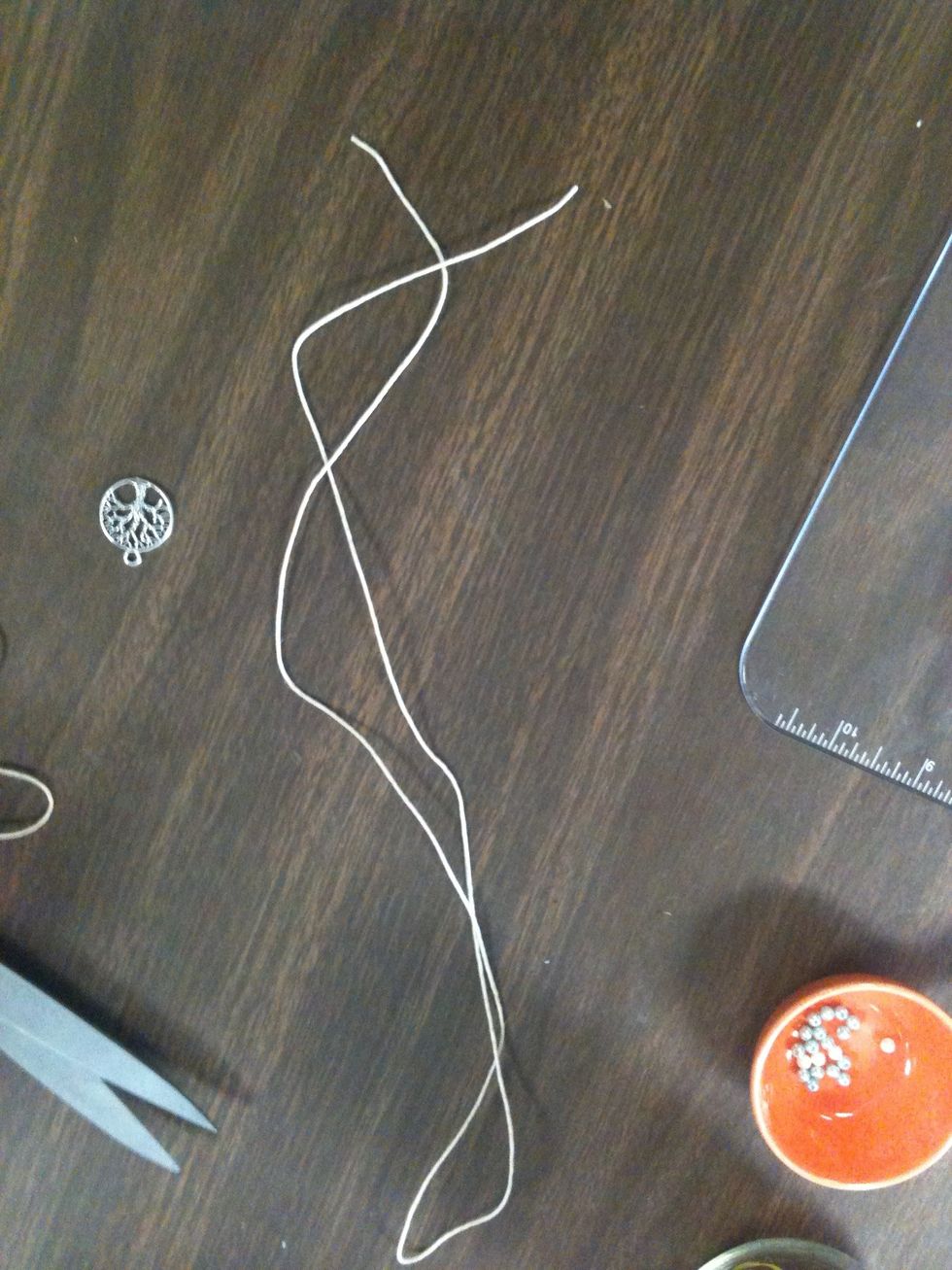 Measure the string around your wrist to see how long you need it. Make the string a little bit longer than your wrist because it is going to be an adjustable bracelet.
