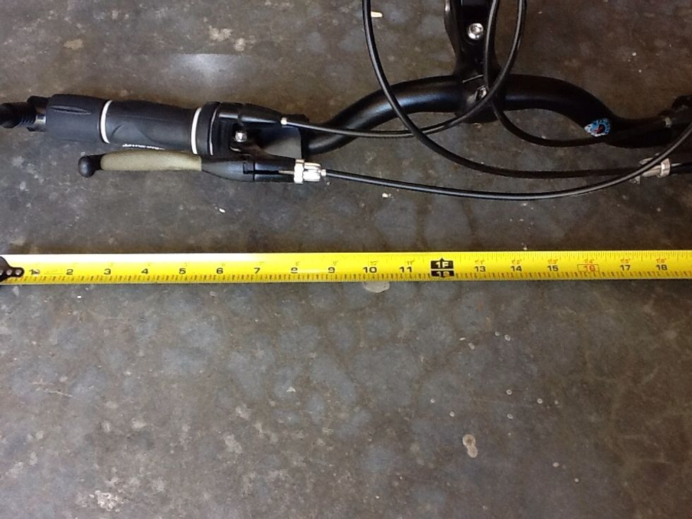 Measure the total width of the handle bars, divide by 2 and add 2 inches to that measurement. The mounting board center will be that distance from the wall.