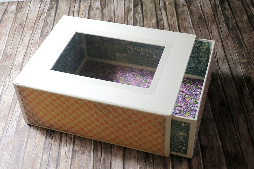 Measure the walls of the drawer, cut the paper down to the needed size and glue it to the drawer panels. You can choose whether to cover the outside of the drawer with paper or not.