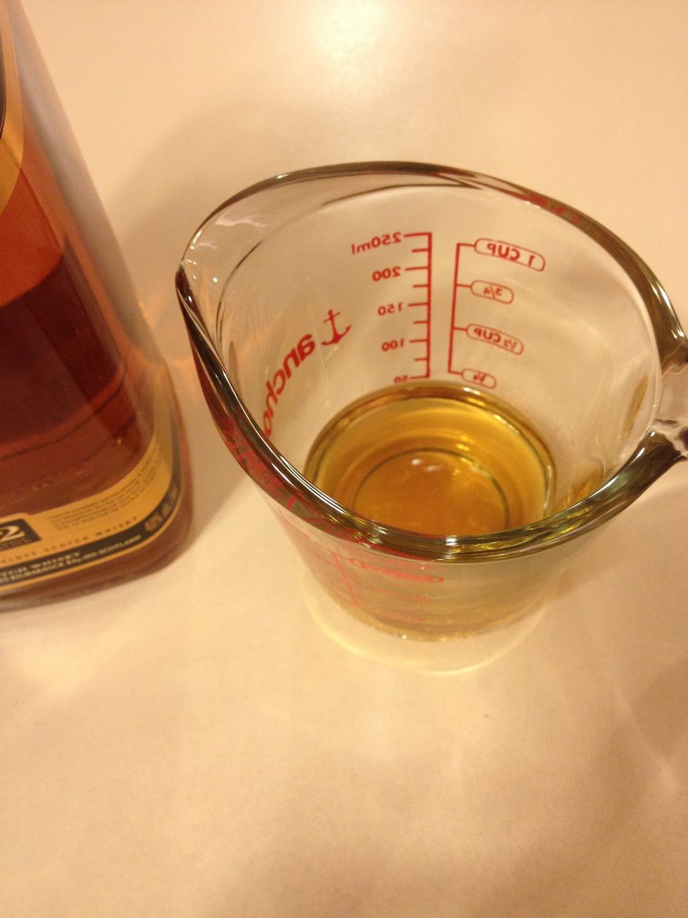 Measure the whiskey and add the vanilla into the same container and set aside.