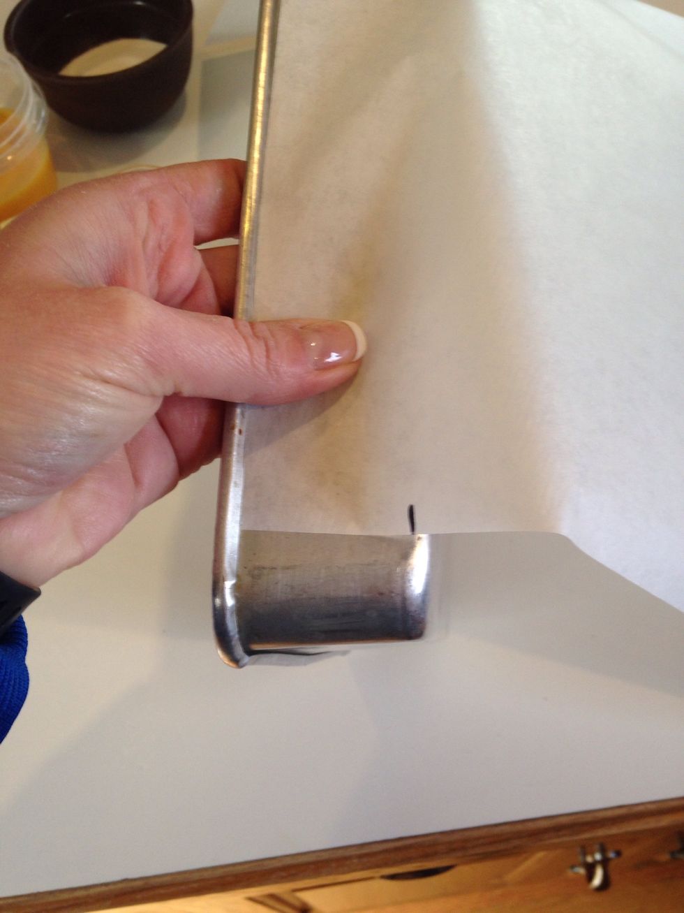 Measure the width of the sides and cut long strips of parchment to wrap the entire inside of the pan.