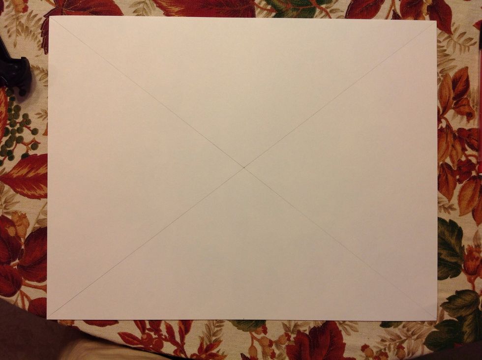 Measure to find the center of your paper. This will be your vanishing point. Lightly pencil in a diagonal line from corner to corner. Make sure your lines cross through the center point to create an x