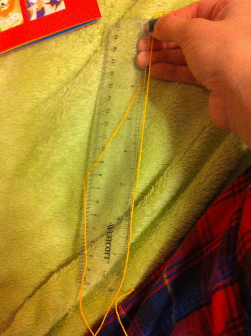 Measure two strings of every color, each 24 inches long. I only have an eight inch ruler so I had to measure it three times to get the 24 inches