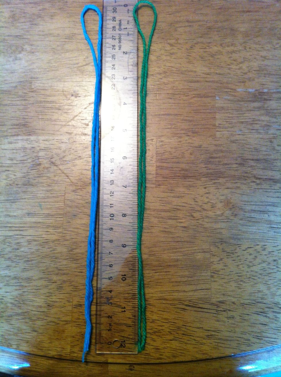 Measure your two colours of yarn and make sure they are, each, 2 feet long (One loop on a 12 inch ruler.)