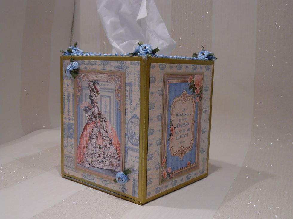 Measured a facial tissue box. Created cover box from greyboard. Edges and corners secured with Gumstrip. Painted with antique gold paint.