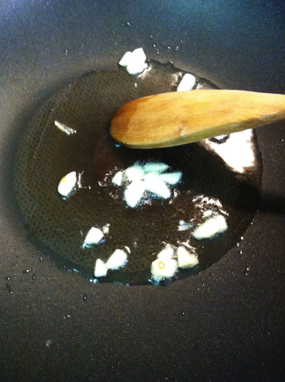 Medium heat the wok then put chop garlic in