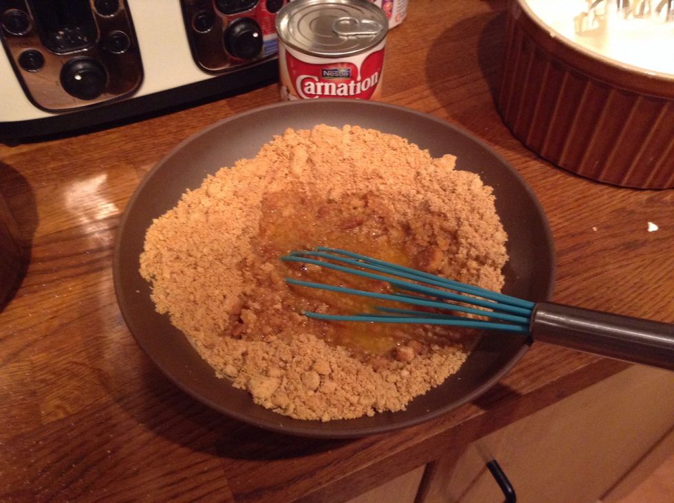 Melt 110g of butter slowly then pour over the crushed biscuits. Use your fingers to coat the crumbs if your feeling adventurous