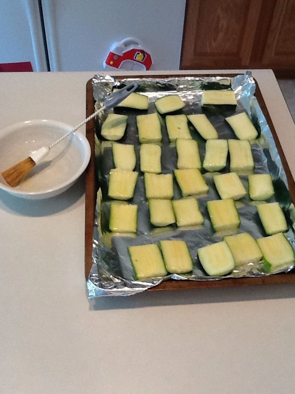 Melt butter and baste each zucchini strip, coating well.