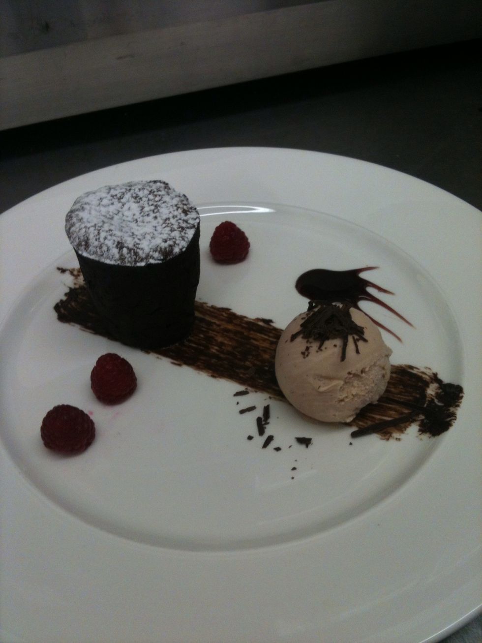 Melt butter and choc over Bain Marie, whisk eggs and sugar unil pale, combine the two slowly, fold in the flour, put into buttered and cocoed moulds. Cook at 180 for 8 mins. Wa la!!!