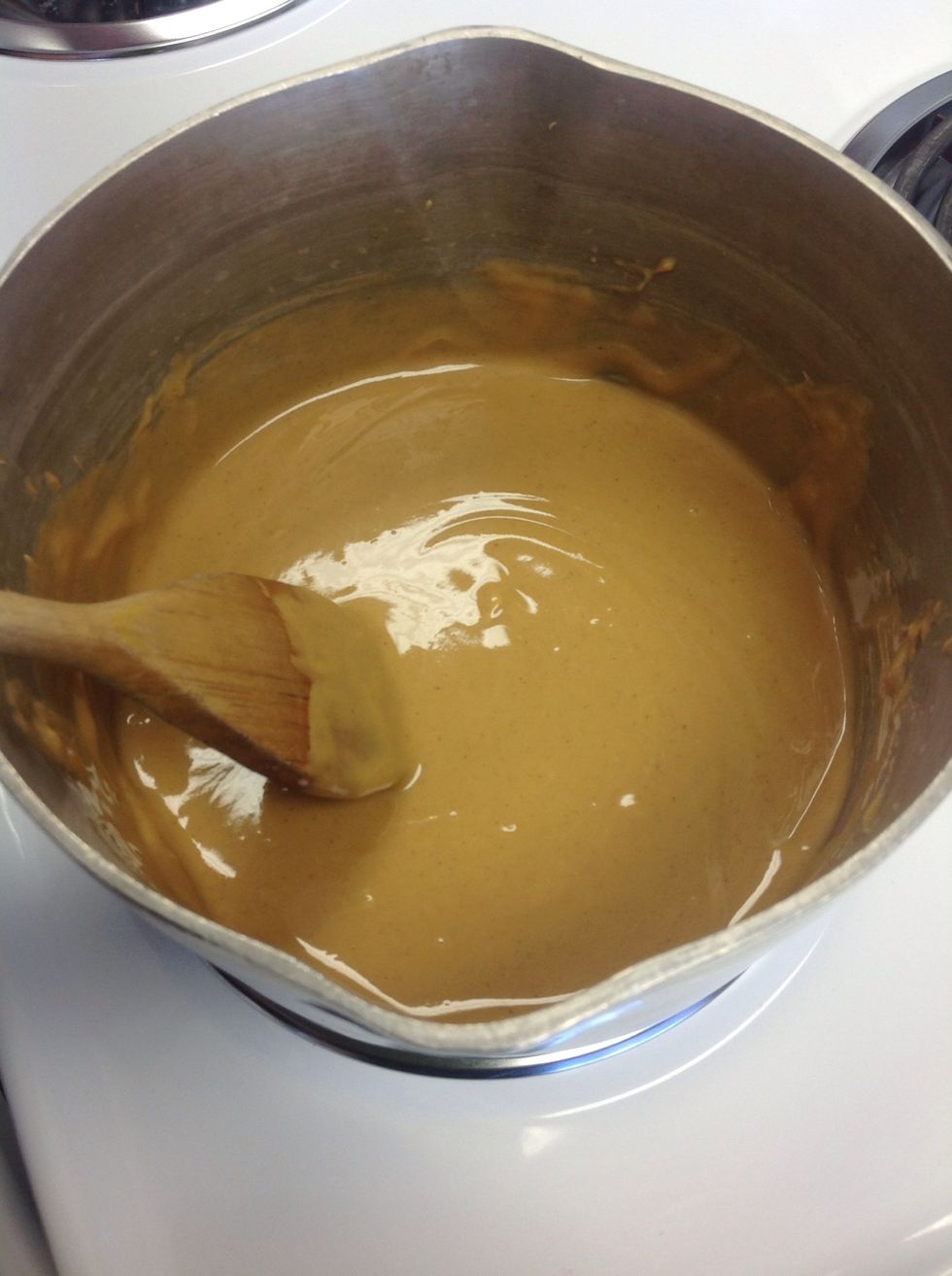 Melt butter and Reese's peanut butter chips into a sauce pan. Stir constantly.
