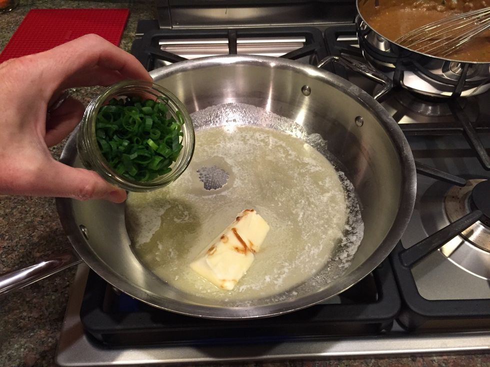 Melt butter and saut\u00e9 green onions briefly