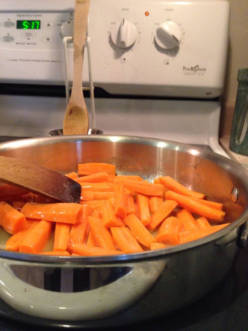 Melt butter over medium heat in a 12 inch saut\u00e9 pan and add carrots.