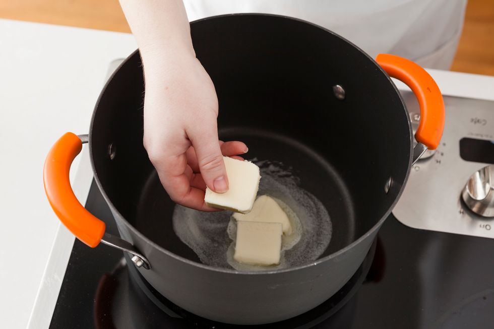Melt butter over medium-high heat in a heavy bottomed pot.