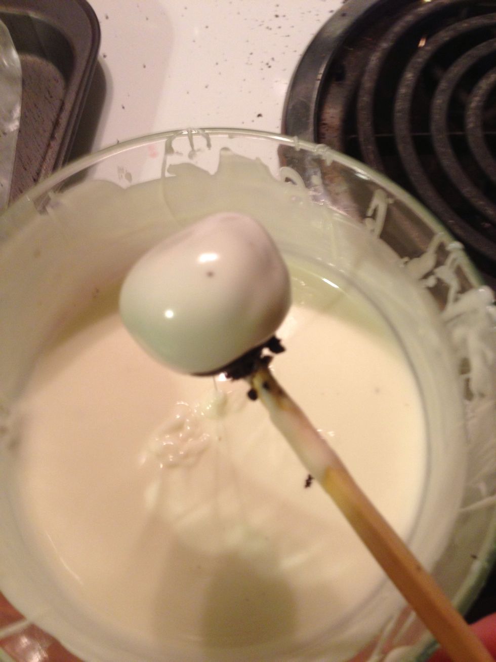 Melt chocolate and then dip balls, covering completely. I used a chopstick to stick the ball. Make sure chocolate is HOT otherwise it won't look so smooth. Reheat if needed. Then back to cookie sheet
