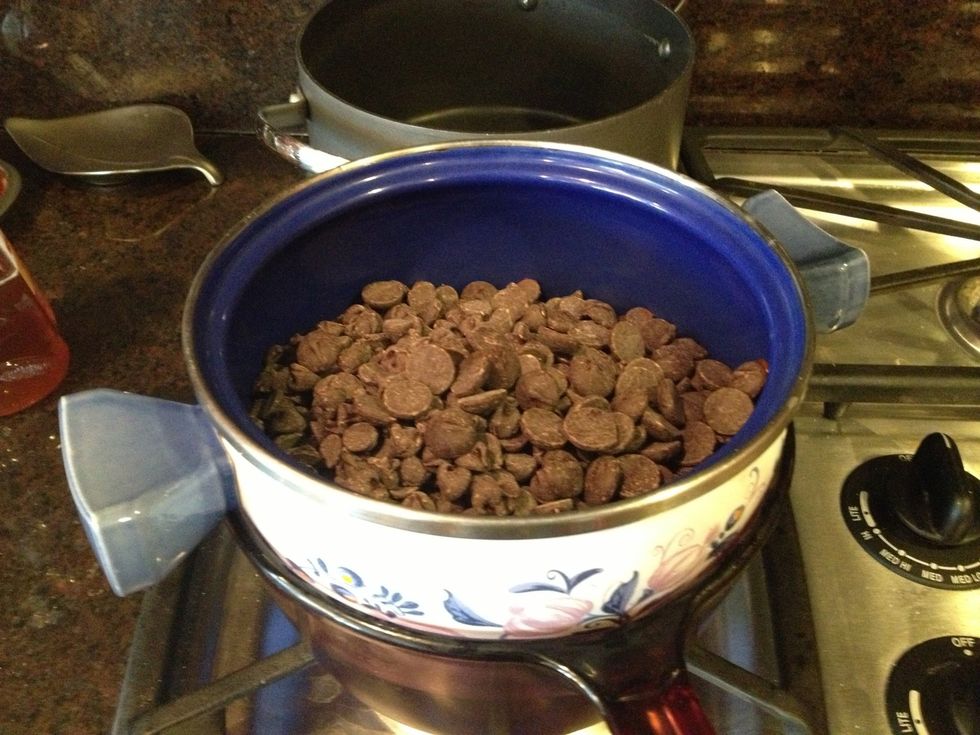 Melt chocolate in a double boiler (a pot set over another one with water in it) over medium low heat. Keep stirring so it melts evenly