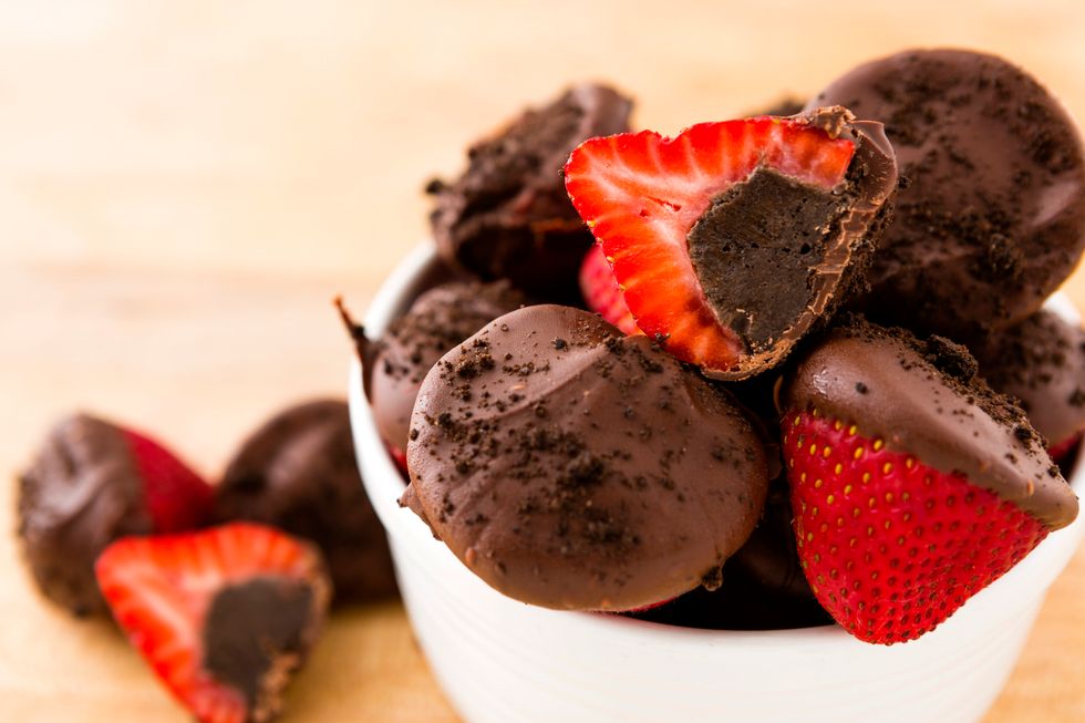 Melt chocolate in a small microwave safe bowl for 30 second invtervals. Dip each strawberry in the melted chocolate.
