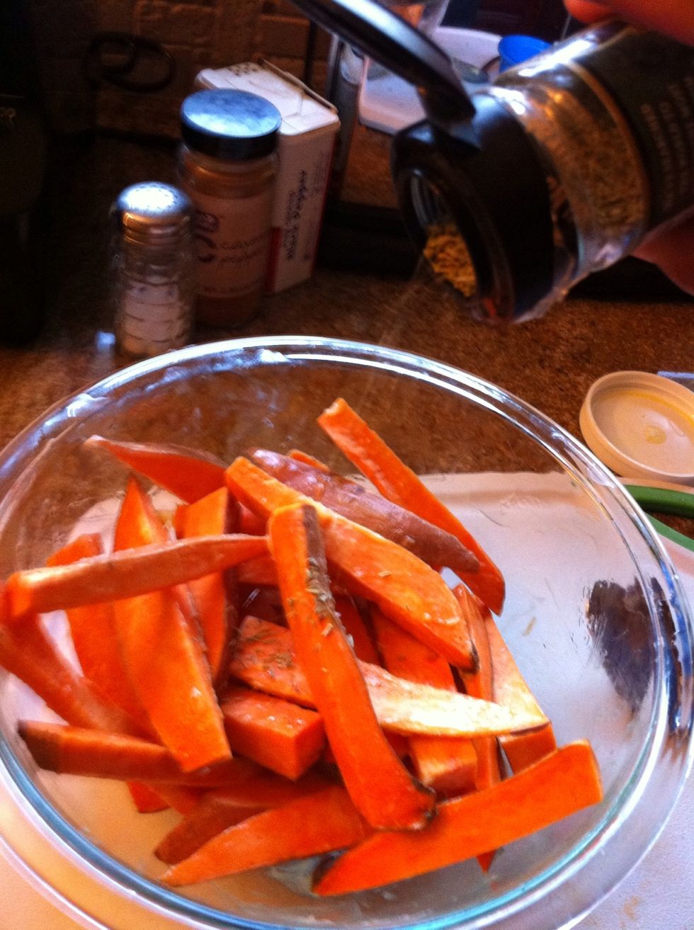 Melt ghee in the microwave and add on top of the sweet potato fries. Mix w your hands. It's messy but most efficient! Add rosemary, cayenne, salt, and pepper. Mix.