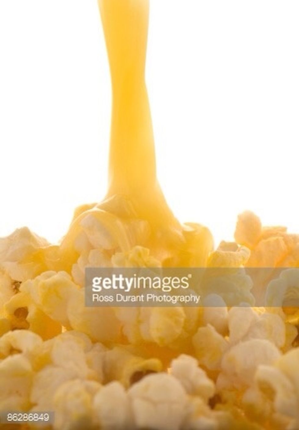 Melt some butter and pour it on top of the popcorn.