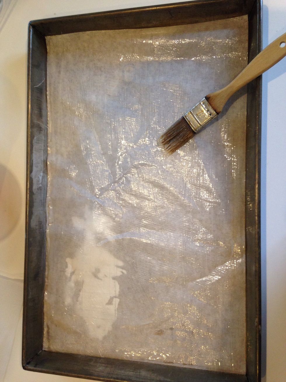 Melt the 10 grams of butter and brush a light layer over the parchment.