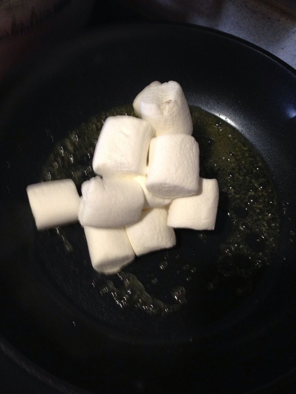 Melt the butter in saucepan over medium heat and add the marshmallow while turning the heat to lowest setting. Continue stirring until all marshmallow melt.