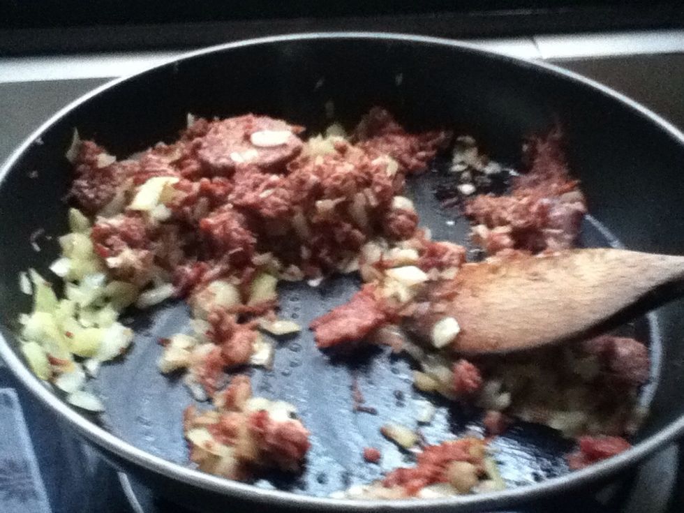 Melt the butter in the pan and saut\u00e9 the onion until soft. Add ground beef and cook until done. Season with salt.