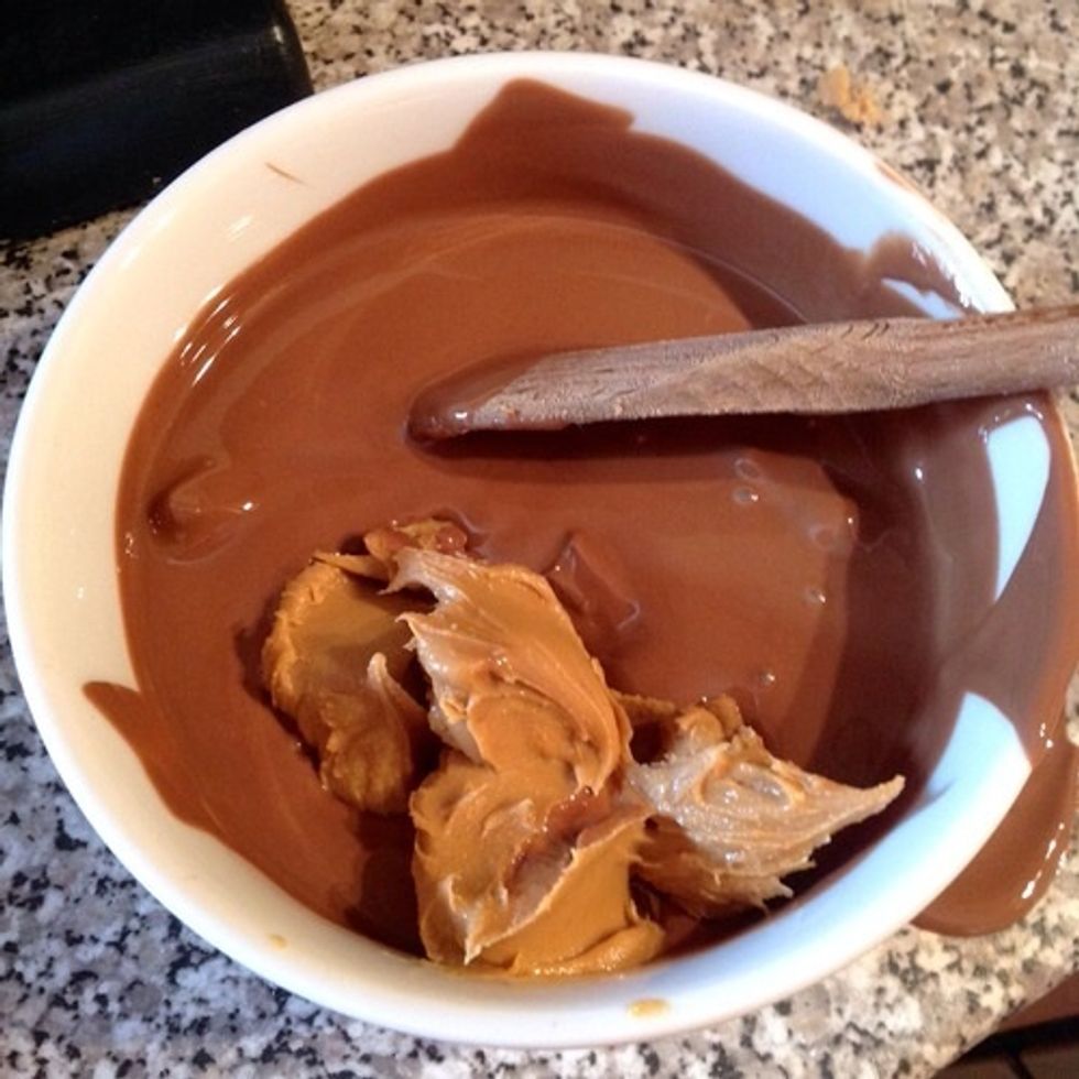 Melt the chocolate and stir in the tablespoons of peanut butter. Keep stirring until it is all completely melted.