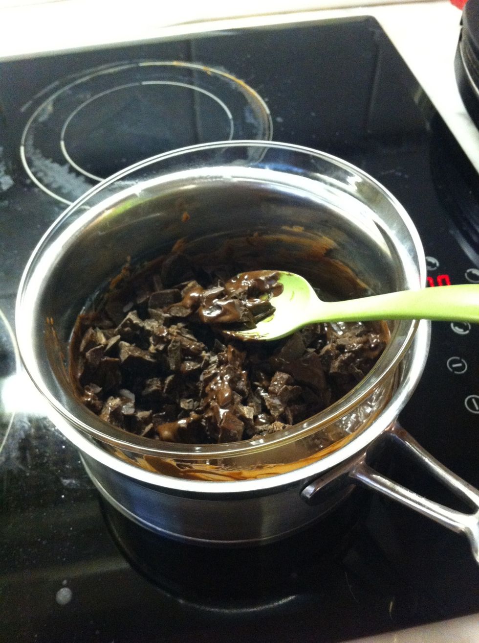 Melt the chocolate in a water heated bowl. Be careful not to allow any water in the mixture as this will render the chocolate impossible to melt. Use a bowl almost as big as the pot.